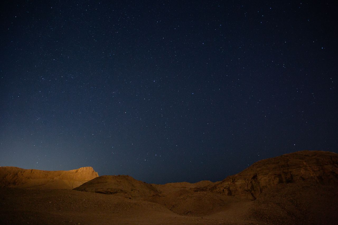 A stunning view of the starry night sky above the desert hills in Esna, Egypt.